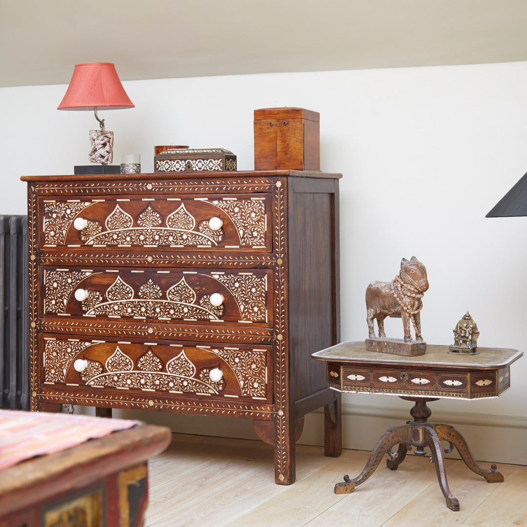 A bone inlay chest of drawers and a smaller side table also made using bone inlay. 
