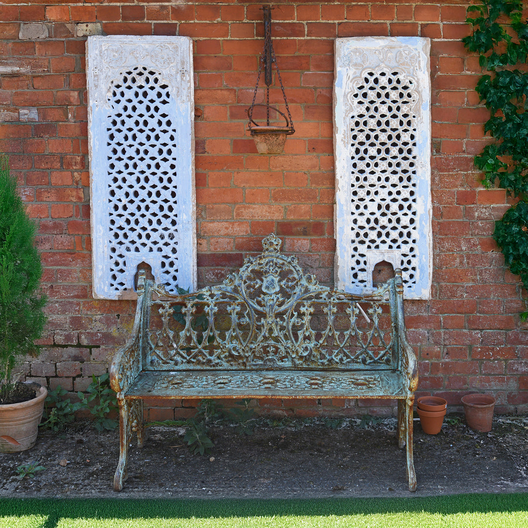 Traditional Anglo-Indian garden with blue jali artwork & cast iron outdoor bench