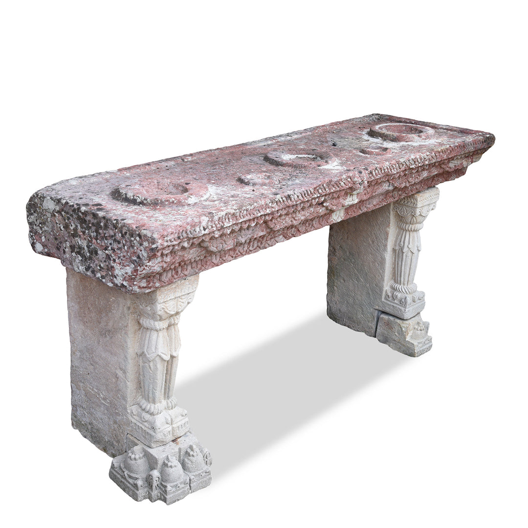 Angled View Of Antique Indian Parinda Water Pot Stand With Carved Red Sandstone Top And Ornate White Stone Legs