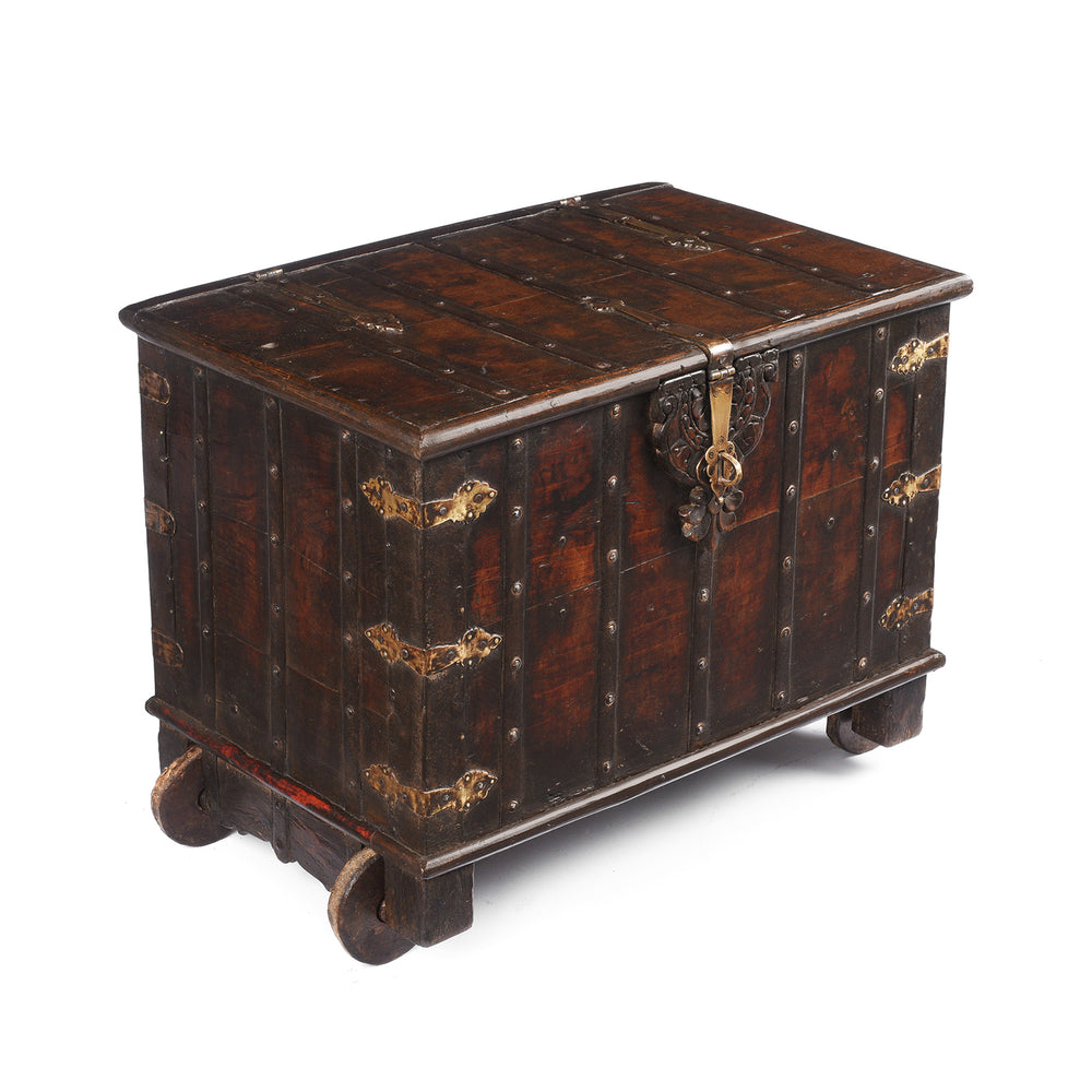 Angled View Of Antique Indian Brass Bound Teak Chest On Wheels | Indigo Antiques