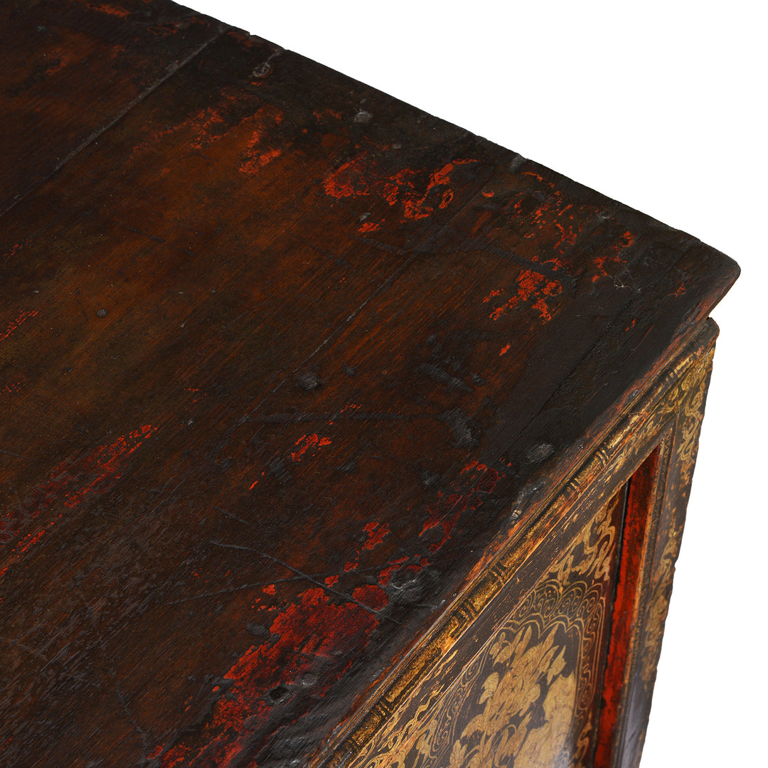 Top Corner Showing Patina And Old Red Paint From Gilt & Black Painted Tibetan Altar Cabinet | Indigo Antiques 