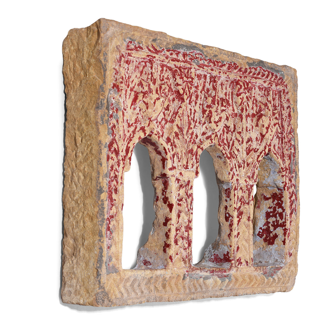 Angled View Of 3 Way Red Painted 19th Century Jaisalmer Sandstone Lamp Niche With Triple Arched Openings And Carved Detailing | Indigo Antiques