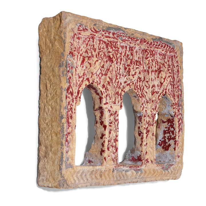 Angled View Of 3 Way Red Painted 19th Century Jaisalmer Sandstone Lamp Niche With Triple Arched Openings And Carved Detailing | Indigo Antiques