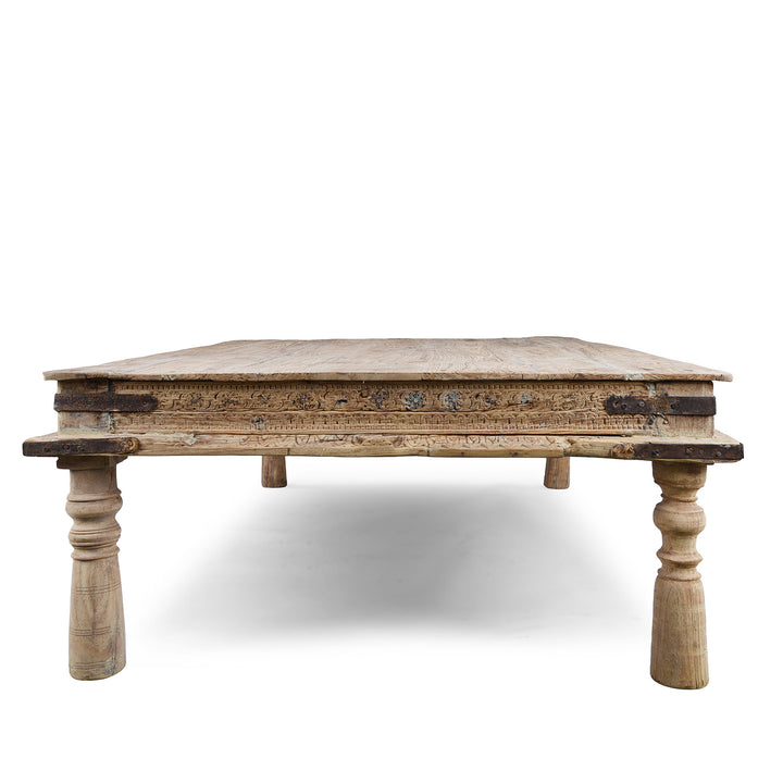 Side View Of Bleached 19th Century Teak Takhat Daybed From Hyderabad With Hand Carved Floral Frieze And Turned Legs | Indigo Antiques