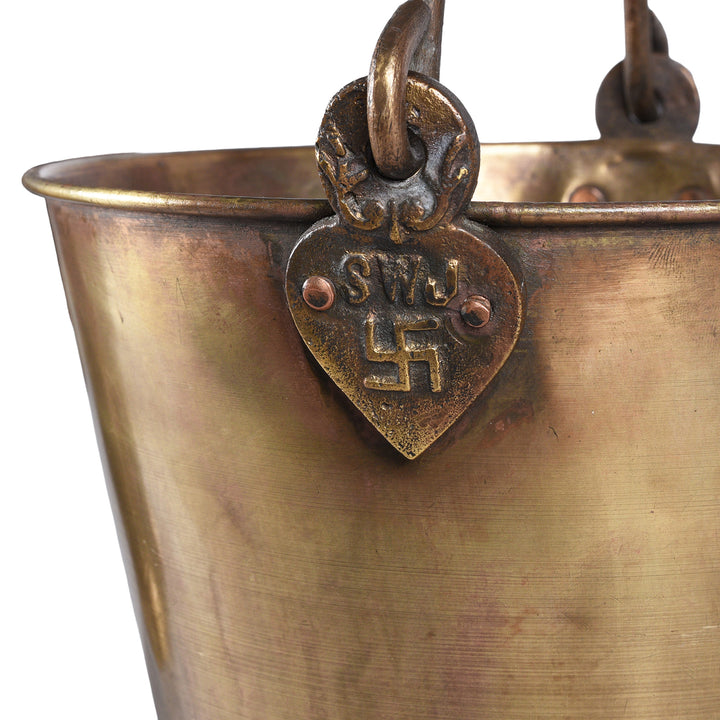 Swaztica Detail From Indian Brass bucket with handle on a white background