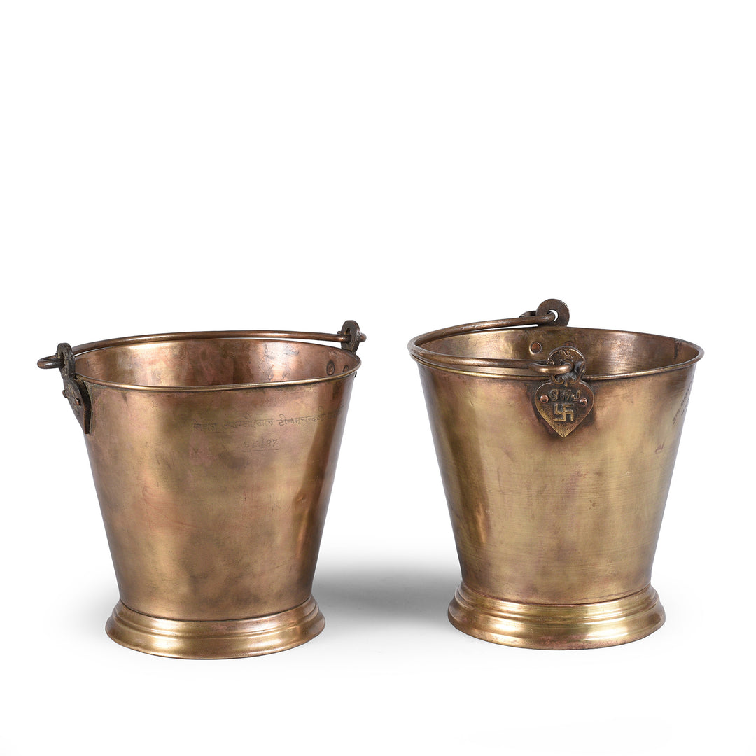 Pair Of Indian Brass buckets with handle on a white background