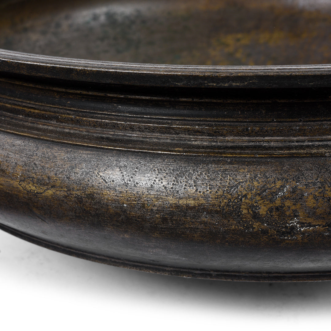 Etching on bronze urli Indian bowl