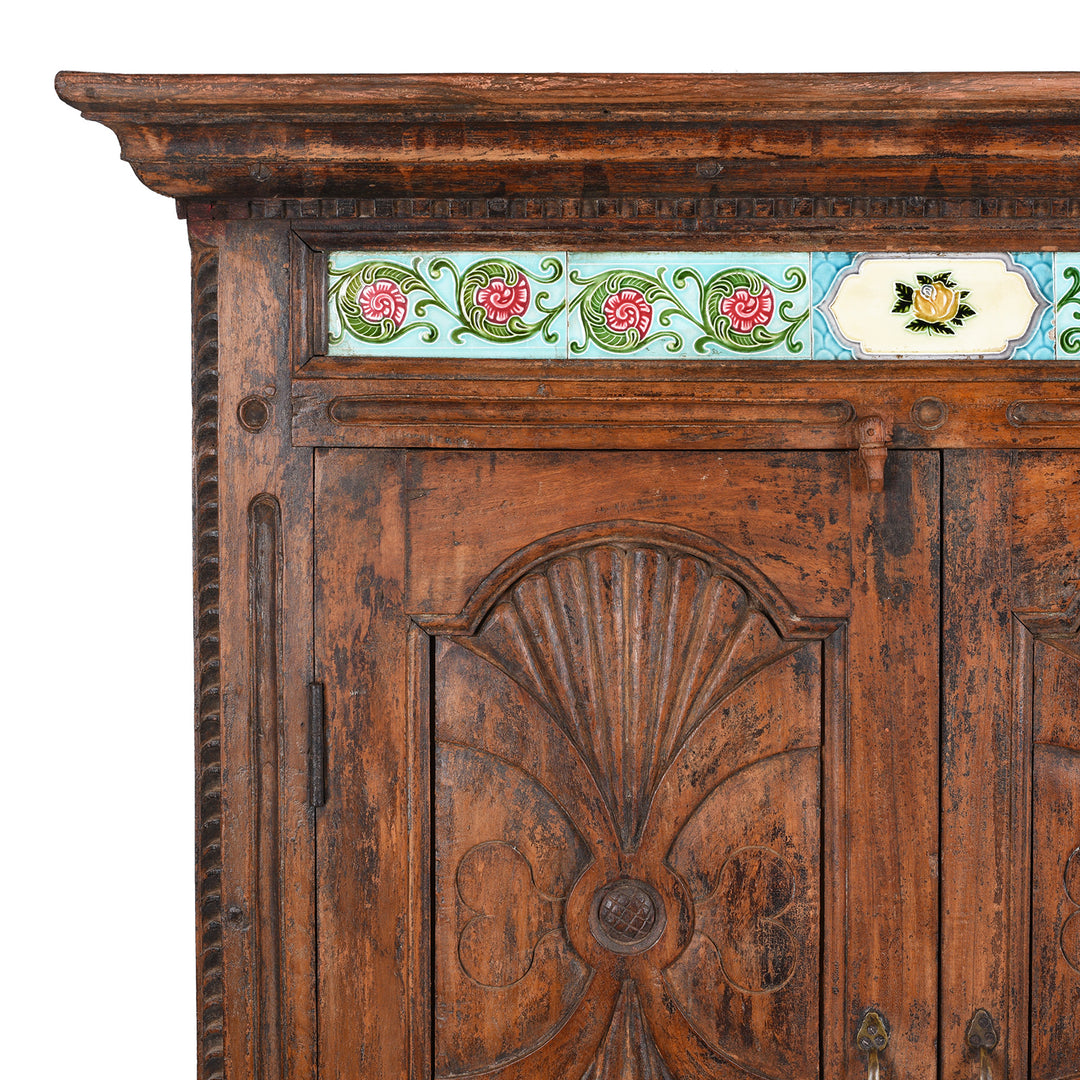 Corner Detail Displaying Carved Surface And Tiles On 19th Century Teak Almirah Cabinet from Gujarat €“ Hand-Carved Panels with Sunburst Motifs and Original Peranakan Ceramic Tiles