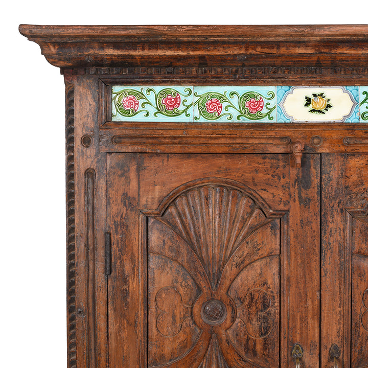 Corner Detail Displaying Carved Surface And Tiles On 19th Century Teak Almirah Cabinet from Gujarat €“ Hand-Carved Panels with Sunburst Motifs and Original Peranakan Ceramic Tiles