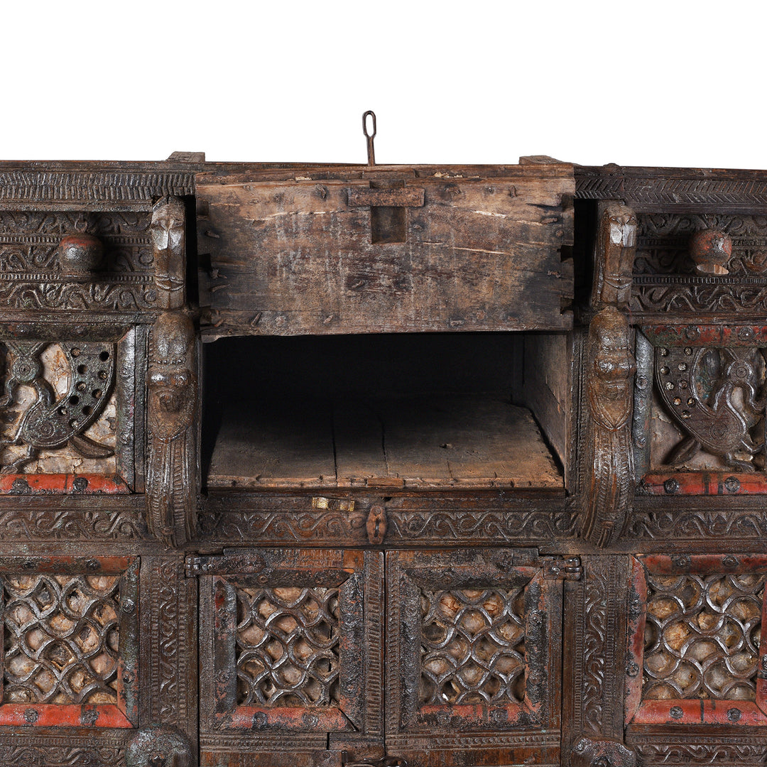 Top Compartment Interior Detail From Antique 19th-century Indian dowry chest from Gujarat with intricate animal carvings, geometric patterns, and hidden compartments, set on wheels.