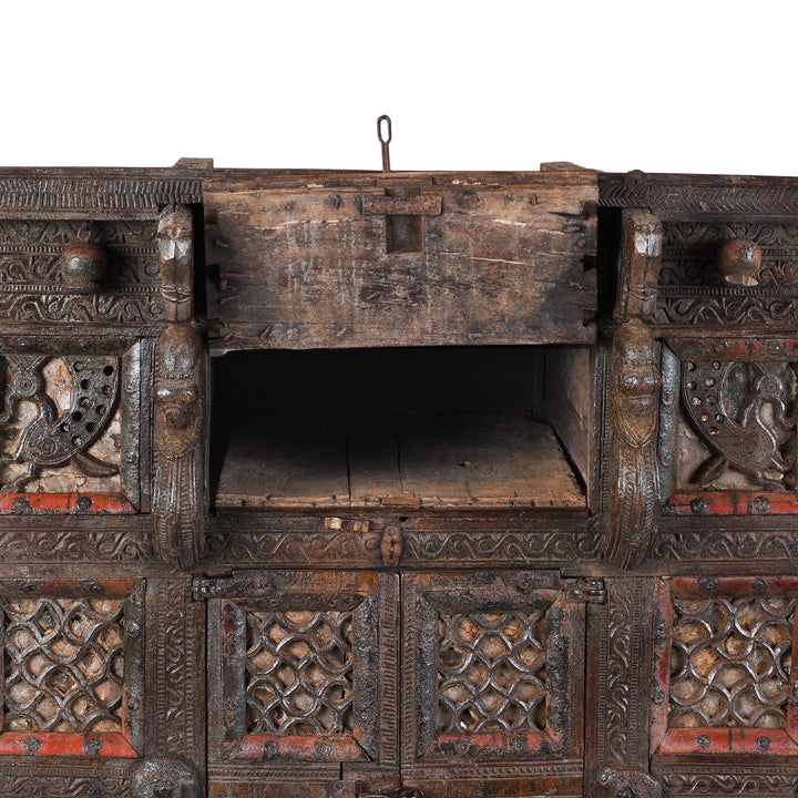Top Compartment Interior Detail From Antique 19th-century Indian dowry chest from Gujarat with intricate animal carvings, geometric patterns, and hidden compartments, set on wheels.