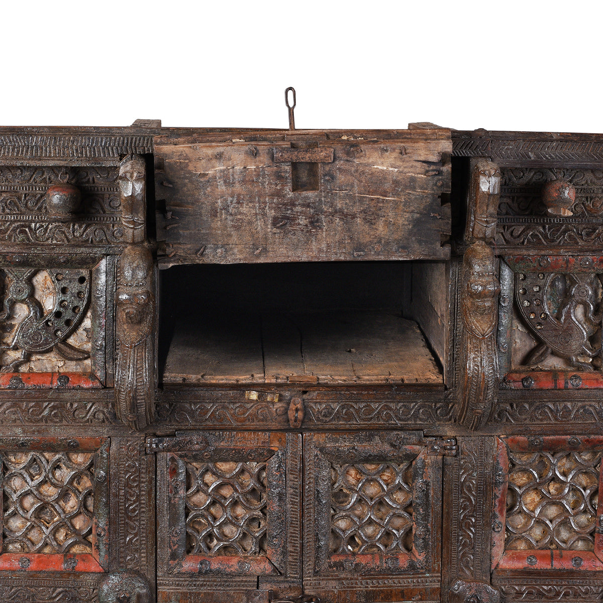 Top Compartment Interior Detail From Antique 19th-century Indian dowry chest from Gujarat with intricate animal carvings, geometric patterns, and hidden compartments, set on wheels.