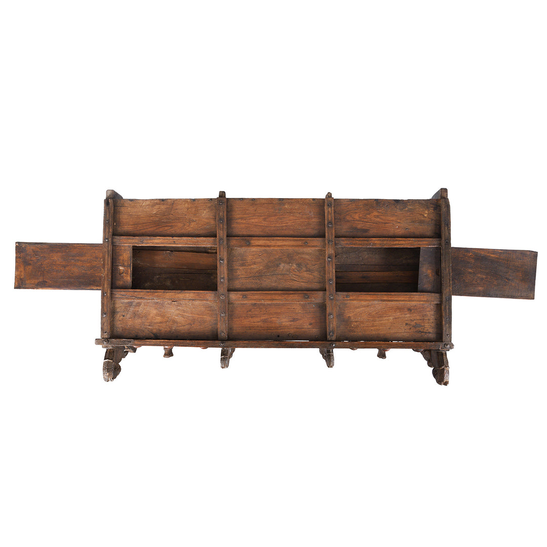 Secret Compartment Detail From Antique 19th-century Indian dowry chest from Gujarat with intricate animal carvings, geometric patterns, and hidden compartments, set on wheels.