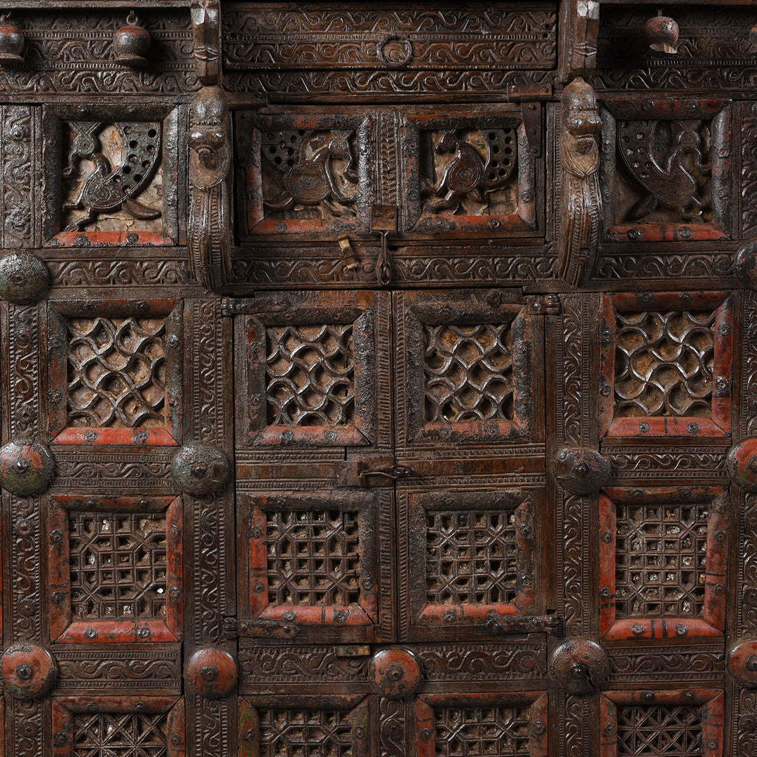 Central Geometric Design Detail From Antique 19th-century Indian dowry chest from Gujarat with intricate animal carvings, geometric patterns, and hidden compartments, set on wheels.