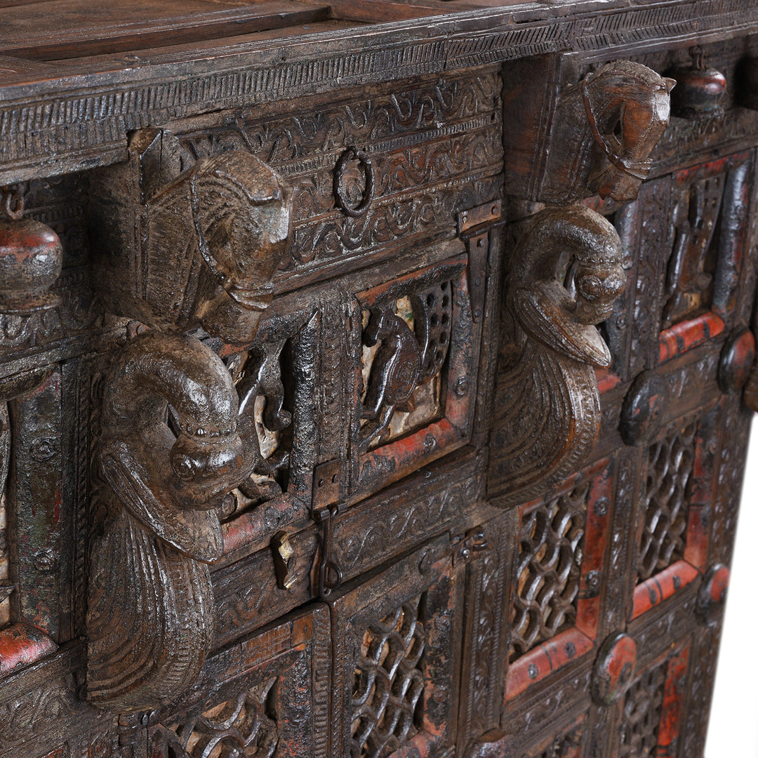 Central Horse Carving Detail From Antique 19th-century Indian dowry chest from Gujarat with intricate animal carvings, geometric patterns, and hidden compartments, set on wheels.