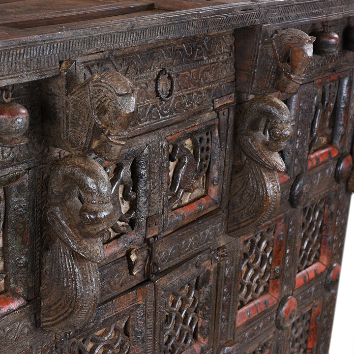 Central Horse Carving Detail From Antique 19th-century Indian dowry chest from Gujarat with intricate animal carvings, geometric patterns, and hidden compartments, set on wheels.