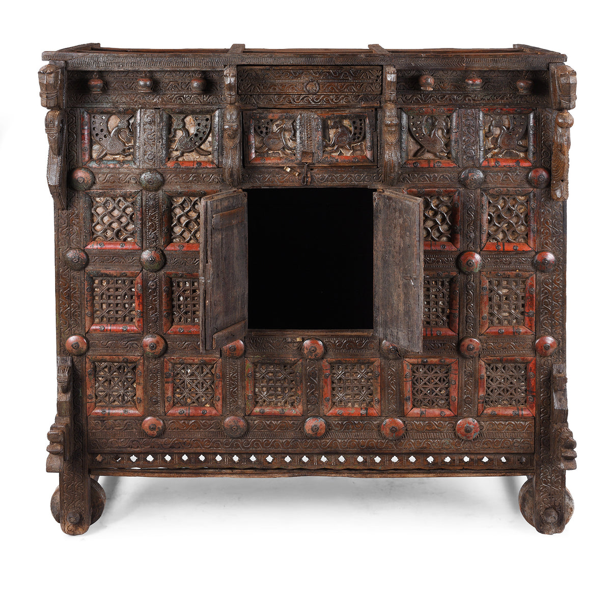 Open Doors View Of Antique 19th-century Indian dowry chest from Gujarat with intricate animal carvings, geometric patterns, and hidden compartments, set on wheels.