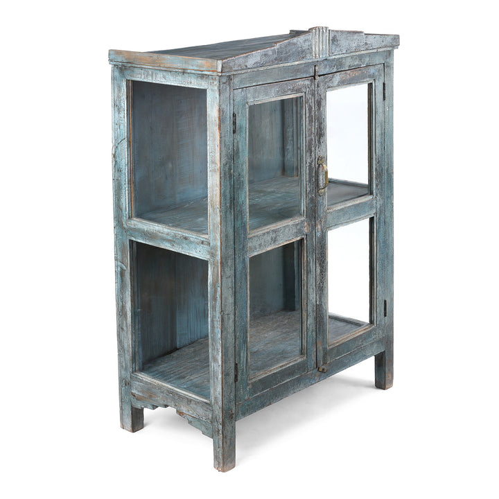 Angled View Of 19th Century Blue Painted Teak Side Cabinet From Gujarat With Original Glazed Panels and Weathered Patina