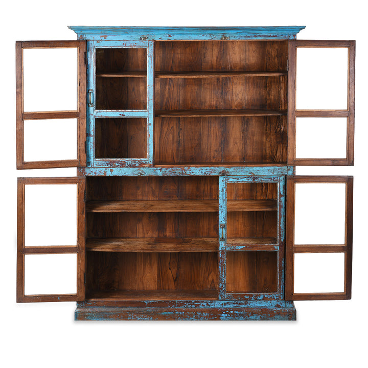 Interior Of Antique Indian Teak Book Cabinet With Distressed Blue Frame, Warm Teak Interior, Five Shelves, And Sliding Central Panels