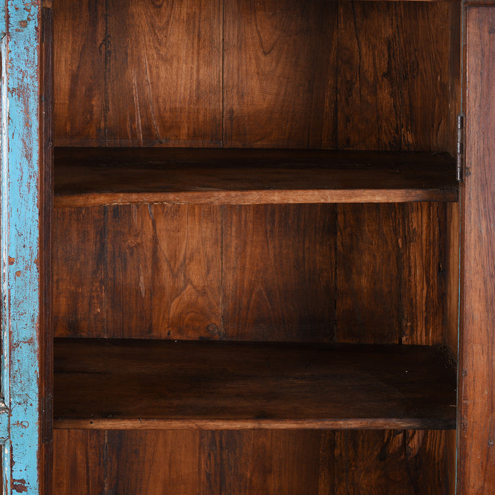 Shelving Detail From Antique Indian Teak Book Cabinet With Distressed Blue Frame, Warm Teak Interior, Five Shelves, And Sliding Central Panels