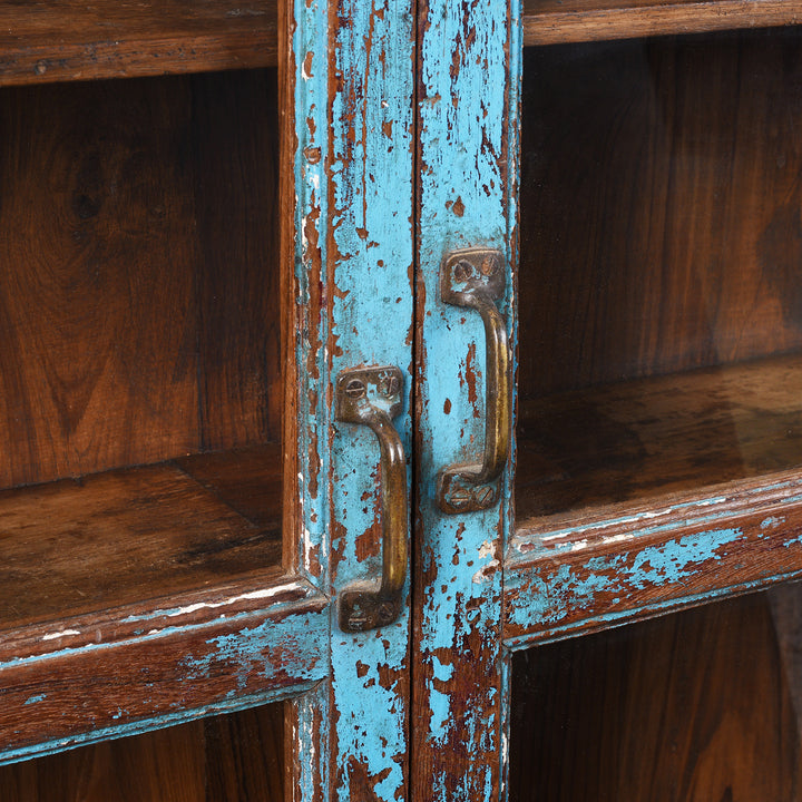 Handles Detail From Antique Indian Teak Book Cabinet With Distressed Blue Frame, Warm Teak Interior, Five Shelves, And Sliding Central Panels
