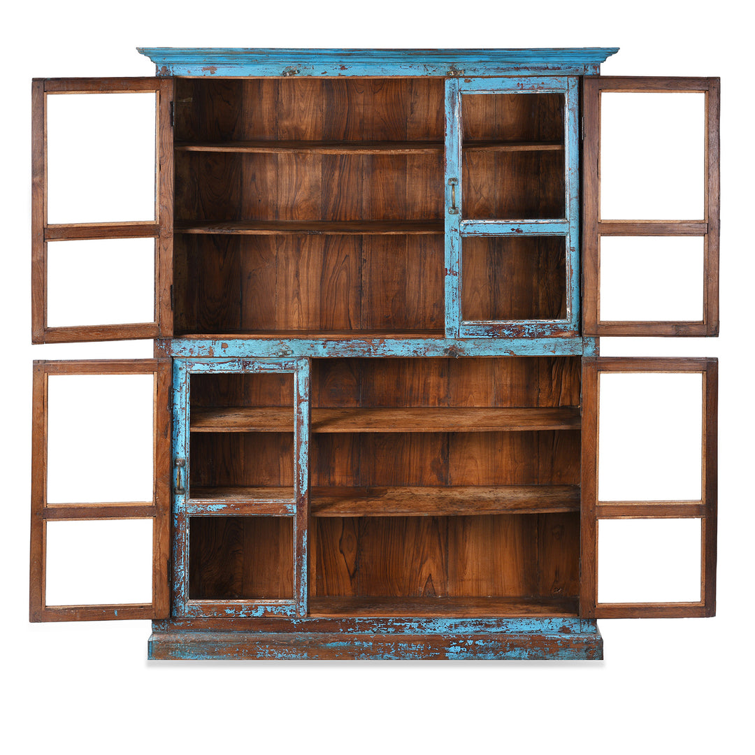 Interior Of Antique Indian Teak Book Cabinet With Distressed Blue Frame, Warm Teak Interior, Five Shelves, And Sliding Central Panels
