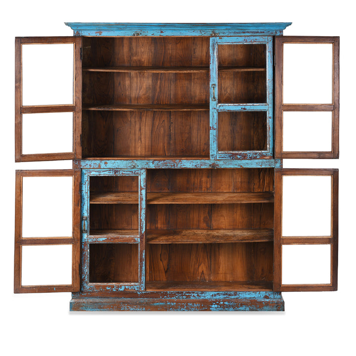 Interior Of Antique Indian Teak Book Cabinet With Distressed Blue Frame, Warm Teak Interior, Five Shelves, And Sliding Central Panels