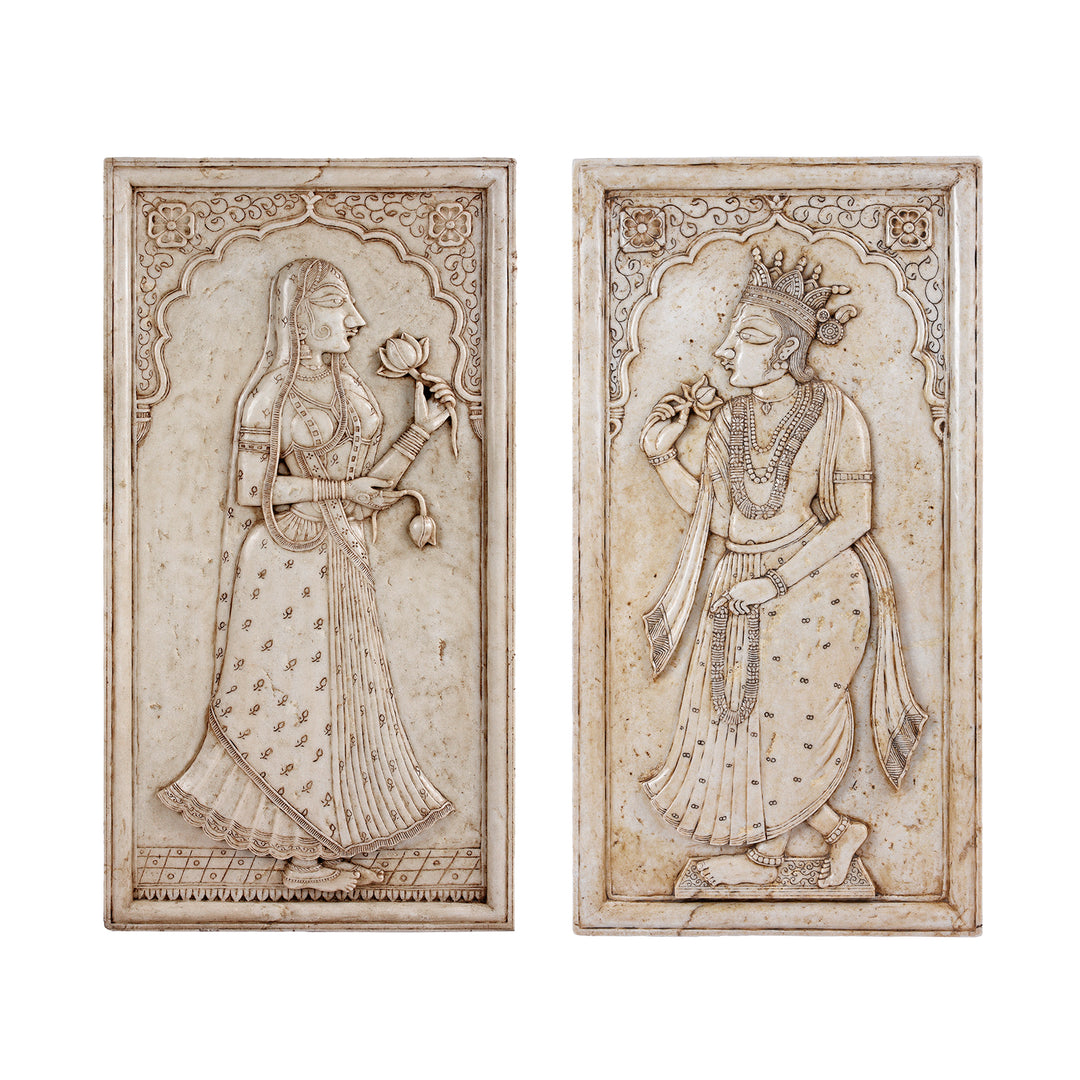 Two decorative panels with intricate carvings of a Maharani and a Maharaja on a marble background