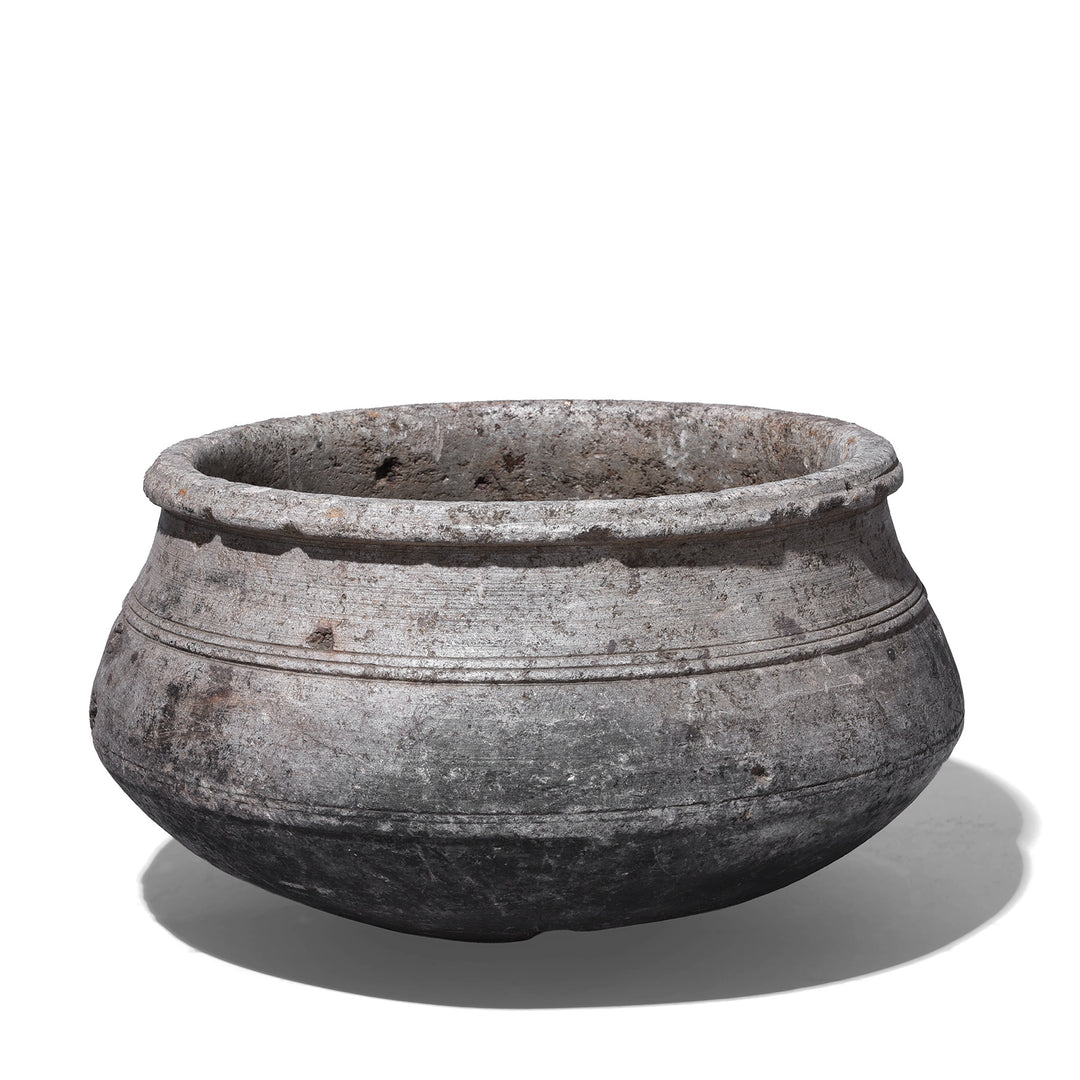 Indian Nineteenth Century Hand Carved Stone Water Pot With Carved Grooves And Aged Surface Used As A Planter