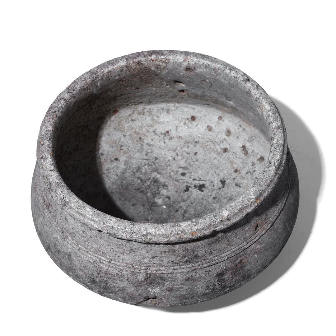 Interior Of Indian Nineteenth Century Hand Carved Stone Water Pot With Carved Grooves And Aged Surface Used As A Planter
