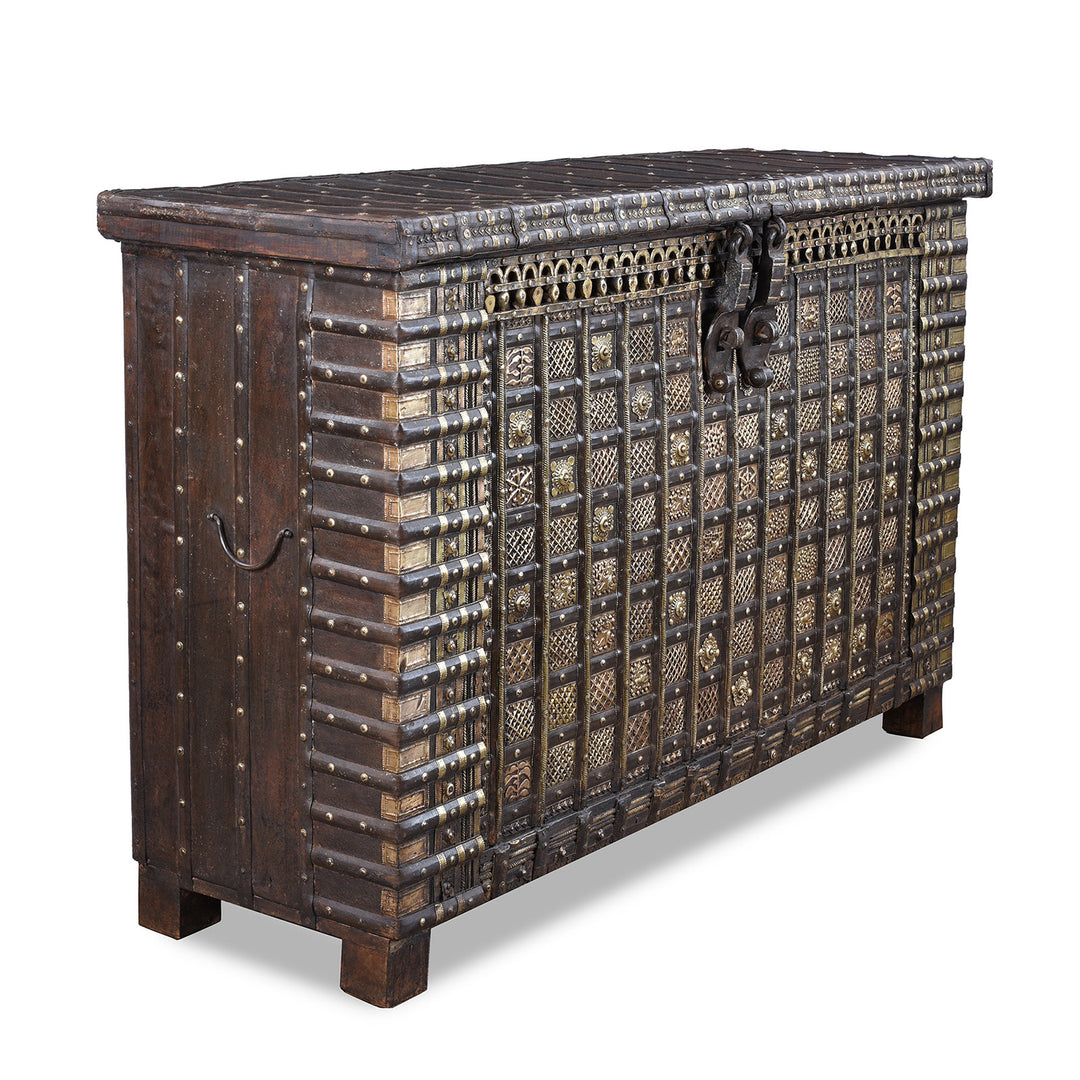 Angled View Of Antique 18th Century Iron Bound Teak Pithara Dowry Chest With Brass Studs Carved Animal Motifs And Interior Chains Adapted As Console Table
