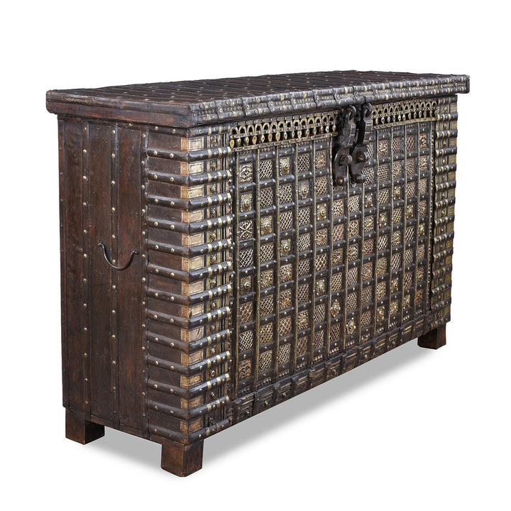 Angled View Of Antique 18th Century Iron Bound Teak Pithara Dowry Chest With Brass Studs Carved Animal Motifs And Interior Chains Adapted As Console Table