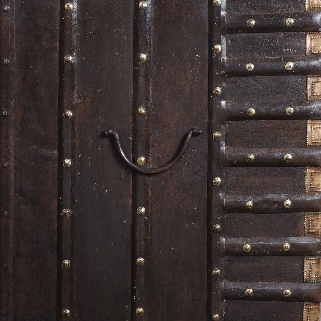 Side Handle Detail From Antique 18th Century Iron Bound Teak Pithara Dowry Chest With Brass Studs Carved Animal Motifs And Interior Chains Adapted As Console Table