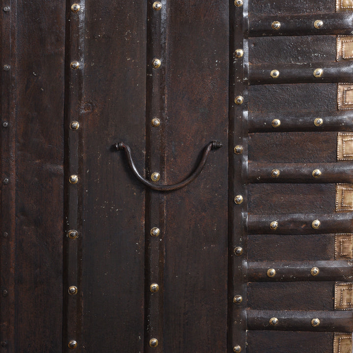 Side Handle Detail From Antique 18th Century Iron Bound Teak Pithara Dowry Chest With Brass Studs Carved Animal Motifs And Interior Chains Adapted As Console Table