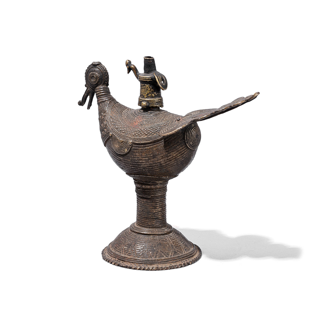 Rear View Of Brass Dhokra Peacock Oil Lamp From Orissa With Geometric Detailing And Aged Patina Circa 1920