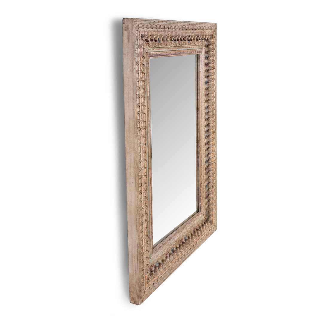 Angled VIew Of Indian Rectangular Hand Carved Mango Wood Mirror With Painted Floral And Geometric Detailing