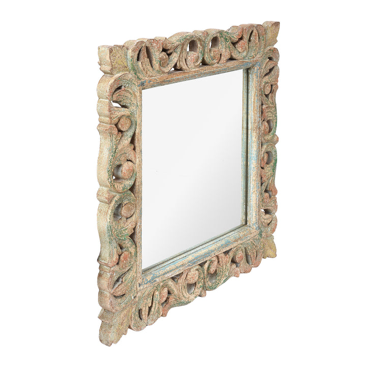 Angled VIew Of Carved Mango Wood Indian Mirror With Green And Red Painted Frame
