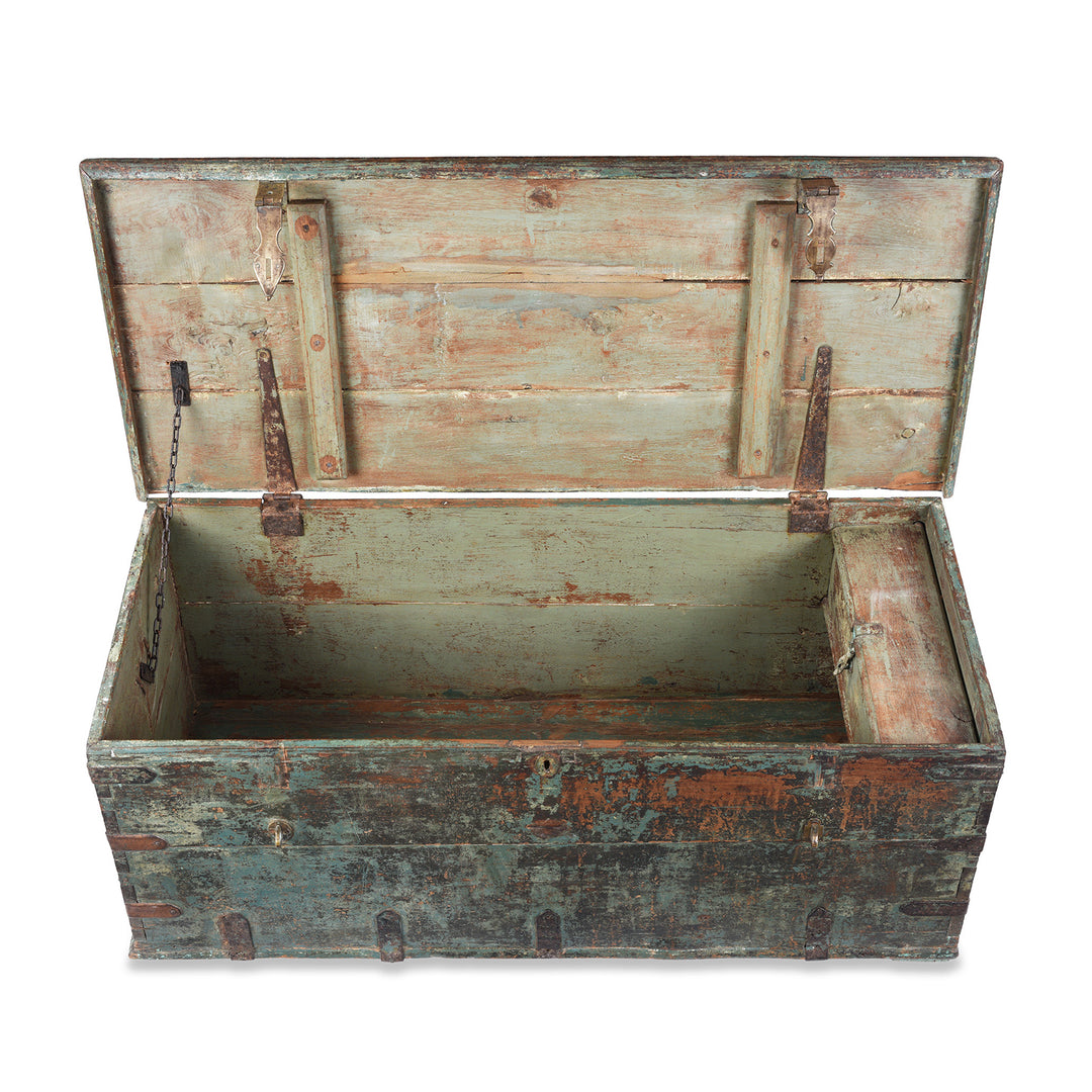 Interior Top Down View Of Indian Antique Painted Teak Chest With Distressed Turquoise And Rust Patina And Iron Strap Detailing