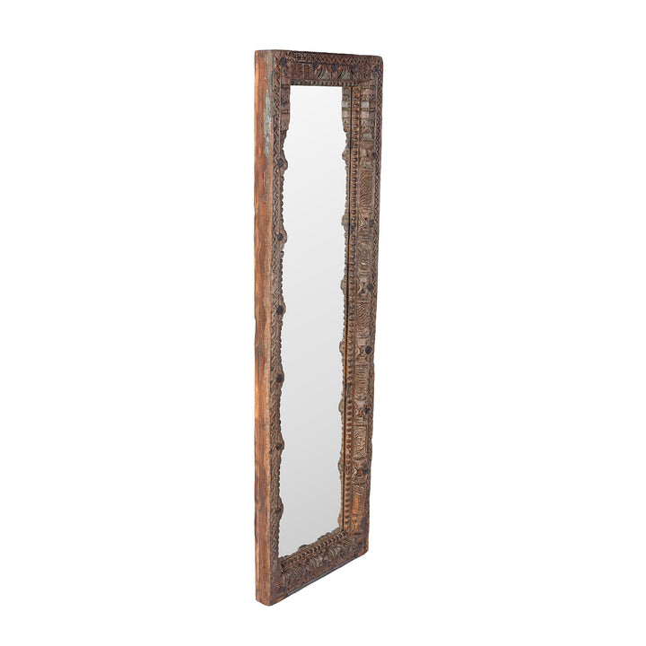 Angled View Of Antique Indian Teak Mirror With Intricately Carved Frame Made From Reclaimed Wood