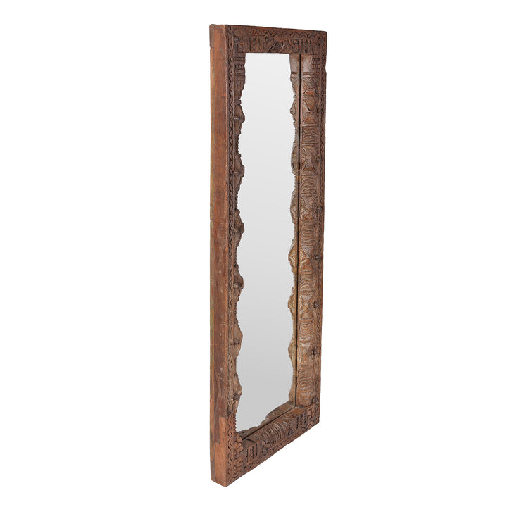 Angled VIew Of Indian Mirror Made From Old Architectural Teak With Intricately Carved Frame And Rustic Weathered Finish