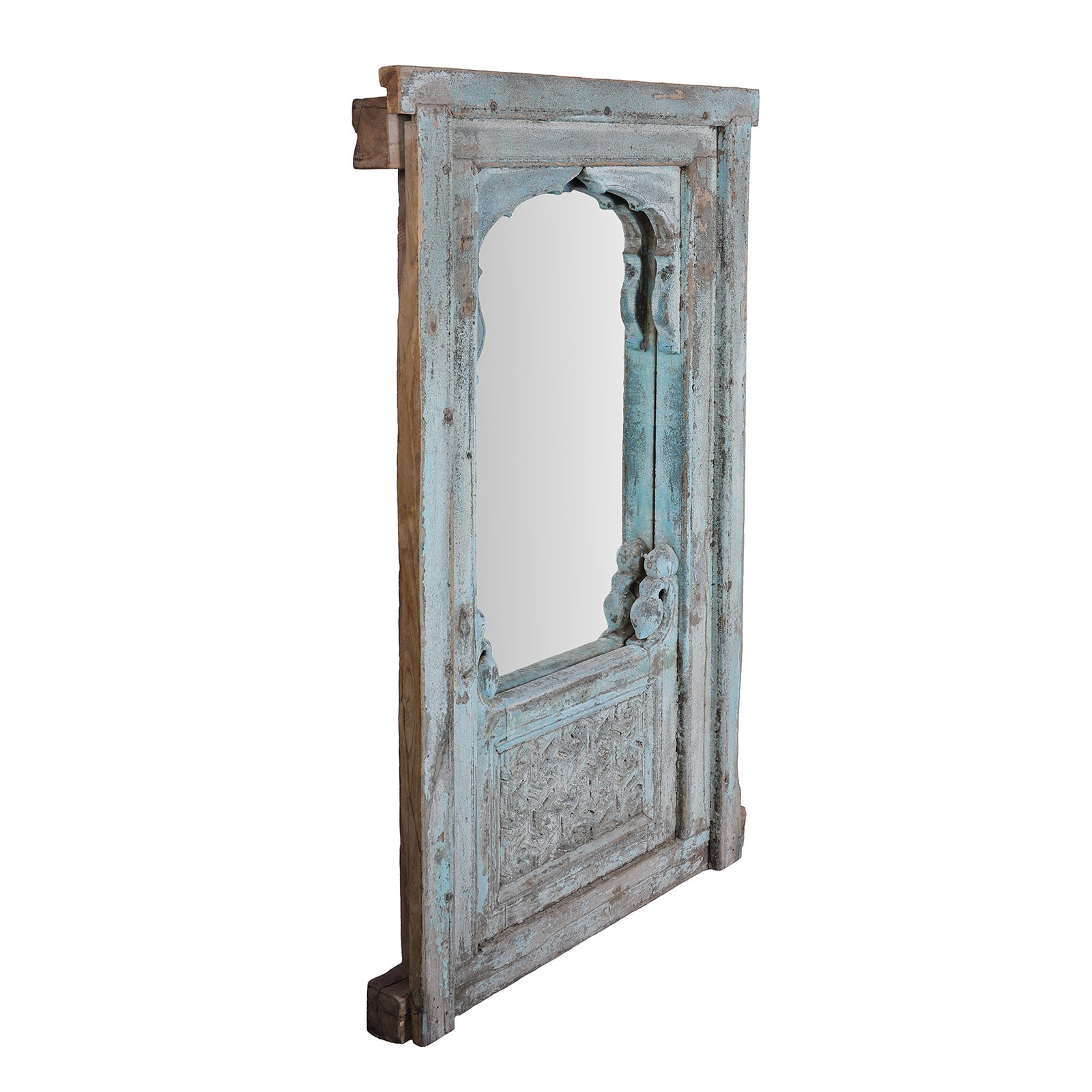 Angled View Of Antique Indian Teak Mirror With Mughal Arch And Carved Base Panel In Distressed Blue Paint