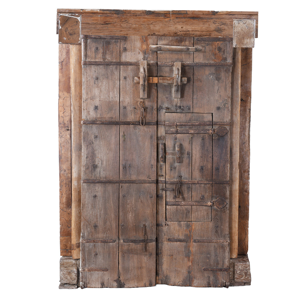 Back Of Antique 19Th Century Kutchi Teak Door And Carved Frame With Wicket Door And Lime Washed Finish From Gujarat India