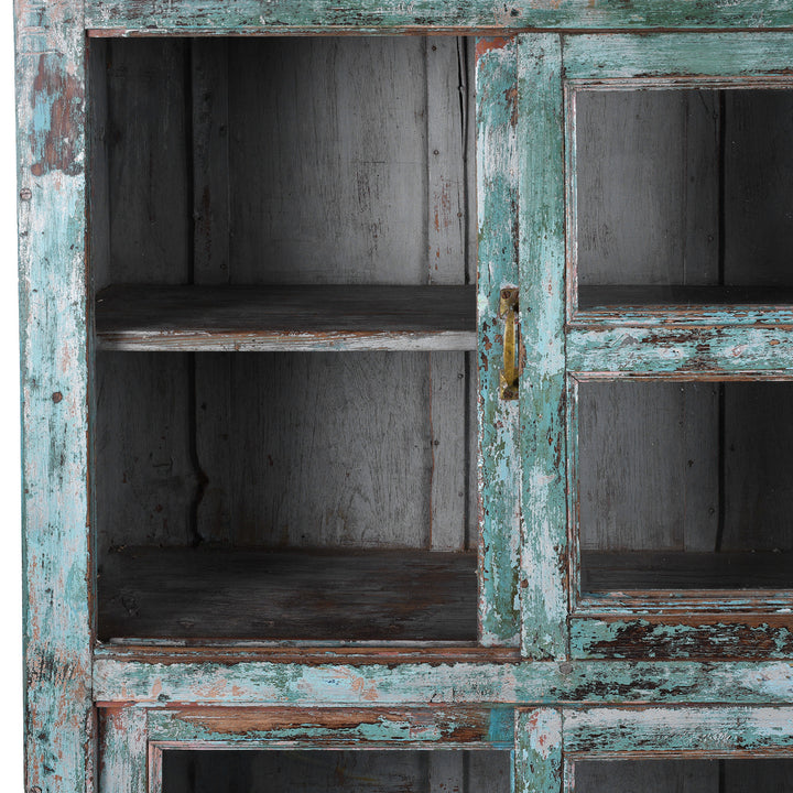 Open Panel View Of Green painted Indian teak glazed cabinet circa 1920 with four sliding glass panels, three fixed shelves and distressed original paint | Indigo Antiques
