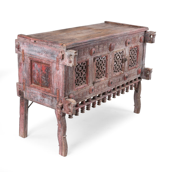 Angled VIew Of Antique 19th Century Indian Majus Dowry Chest From Gujarat With Carved Panels Studs And Red Painted Finish | Indigo Antiques