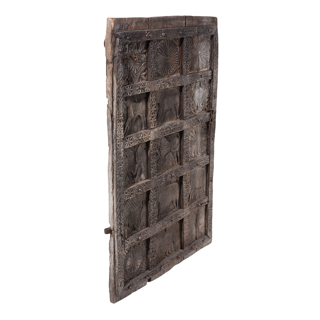 Angled View Of 19th Century Hand Carved Cedar Door Panel From Kullu With Animal And Geometric Motifs | Indigo Antiques