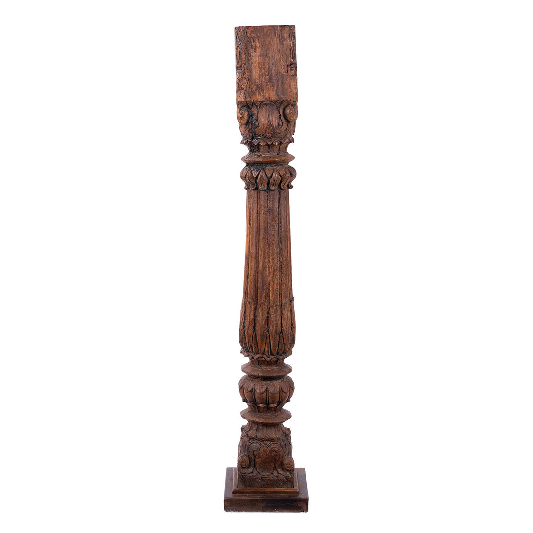 Tall 19th-century Indian carved teak architectural pillar converted into a floor-standing candlestick, with ornate floral carving, rich aged patina and metal candle dish.
