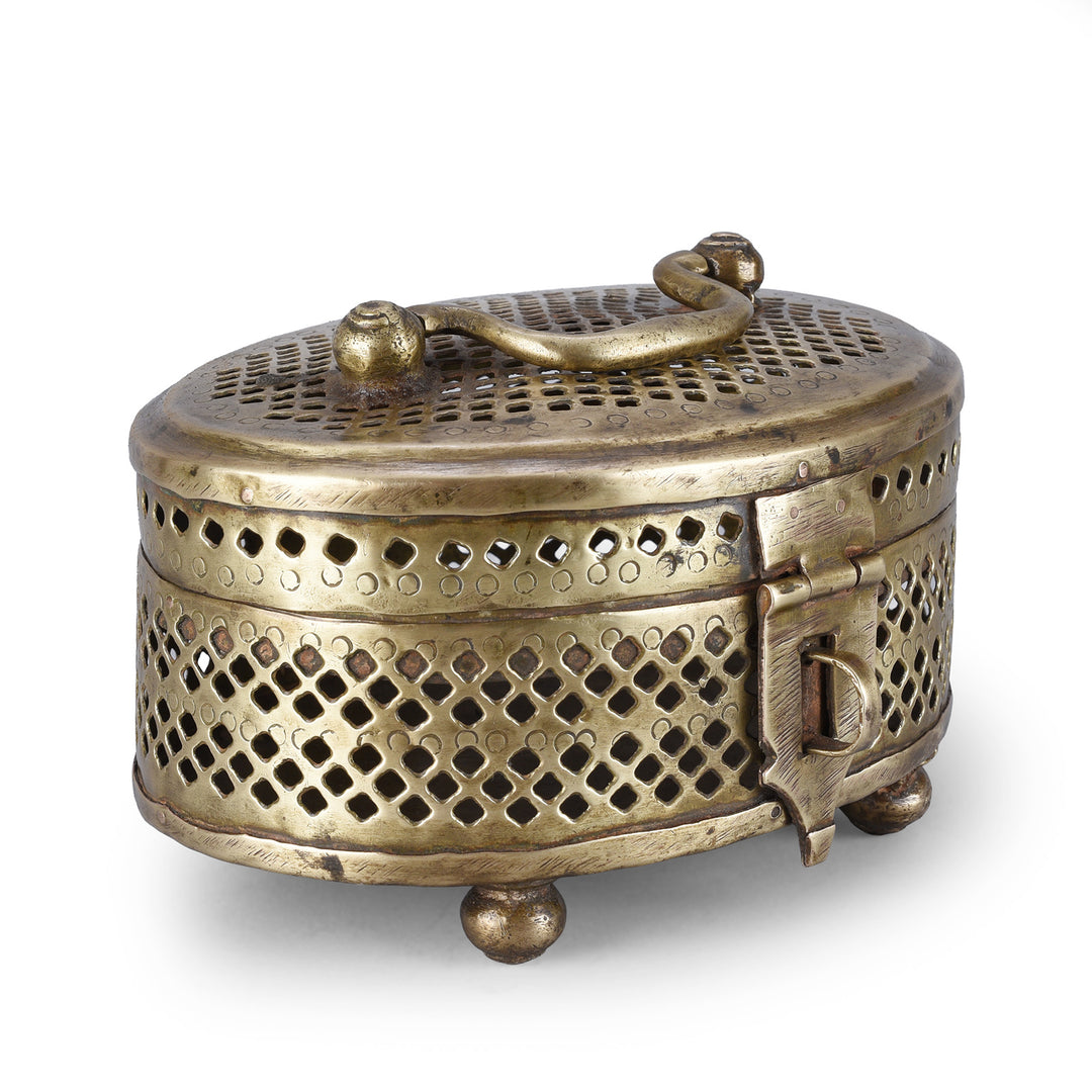 Angled View Of Antique Oval Brass Jali Paandan Box With Pierced Lattice Decoration Hinged Lid Carrying Handle And Decorative Clasp India Circa 1920 | Indigo Antiques