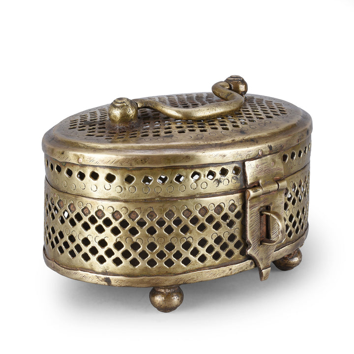 Angled View Of Antique Oval Brass Jali Paandan Box With Pierced Lattice Decoration Hinged Lid Carrying Handle And Decorative Clasp India Circa 1920 | Indigo Antiques