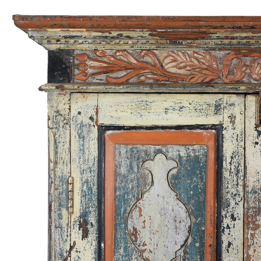 Corner Detail From Painted 19th Century Indian Almirah Cabinet With Distressed Cream Blue And Terracotta Finish Carved Frieze Three Shelves And Two Drawers | Indigo Antiques