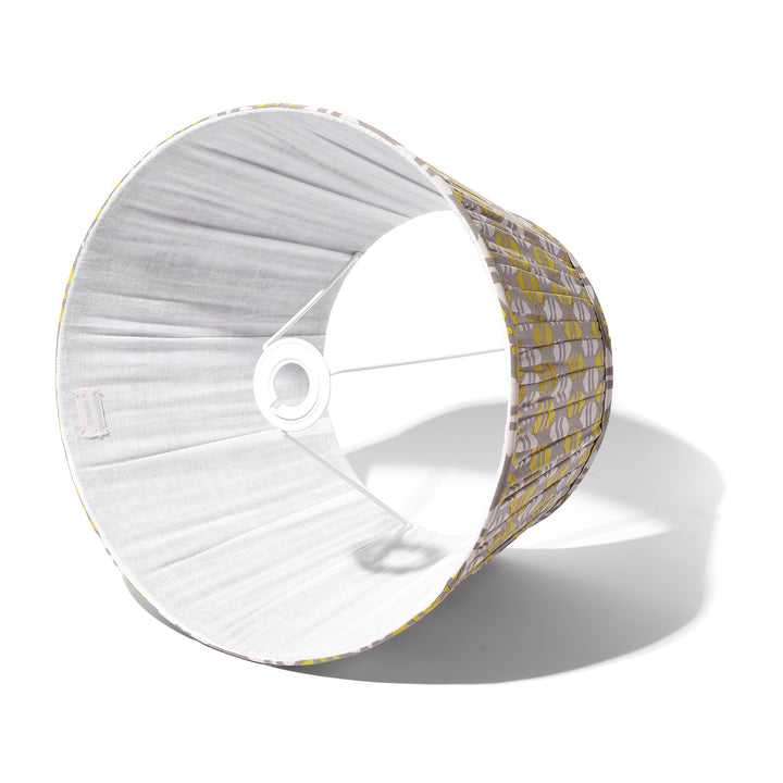 These pleated cotton lampshades have beautiful, subtle, muted tones. The fabric 100% handwoven cotton and made by women in remote Assam, India as part of a project by the Tata Trust to encourage & support women to develop & retain traditional hand-loom skills. Designer, Hillie Grumbar of Samarkand was so impressed with these women's enthusiasm despite their many day-to-day challenges.    Fittings available for a ceiling pendant or lamps